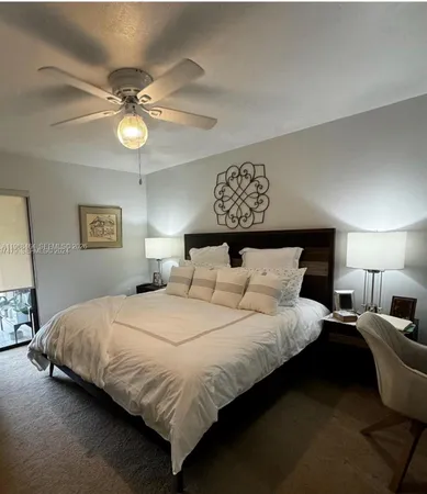 a bedroom with bed and a chandelier