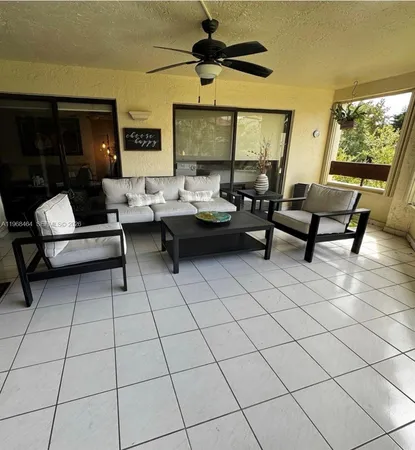 a living room with furniture and a floor to ceiling window