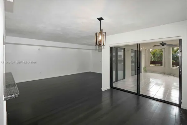 a view of a hallway with wooden floor and a table