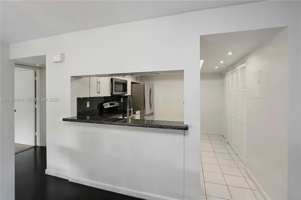 a kitchen with stainless steel appliances a sink and a refrigerator