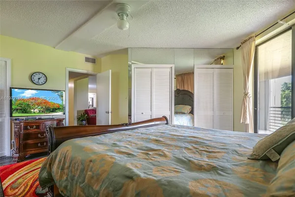 a bed room with a bed and a flat screen tv