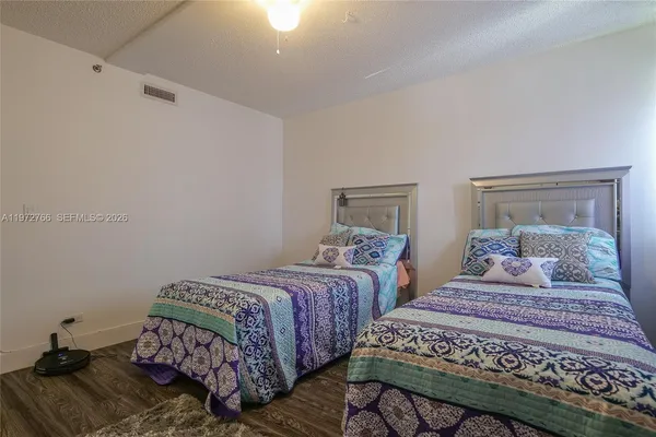 a bedroom with two beds and a mirror