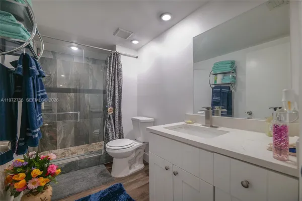 a bathroom with a sink toilet and shower