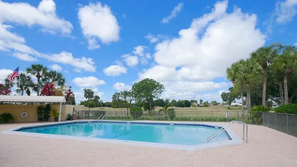a view of swimming pool is middle in the garden