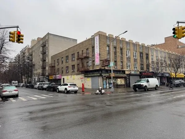 a view of a buildings and car parked on the road