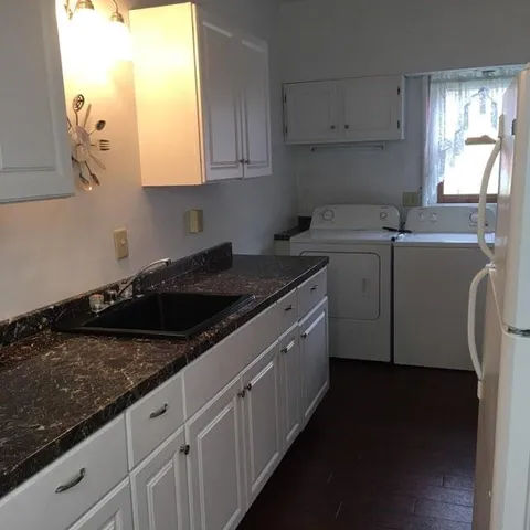 a close view of a sink a stove and dishwasher in a kitchen