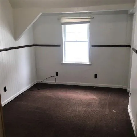 an empty room with a empty space and windows