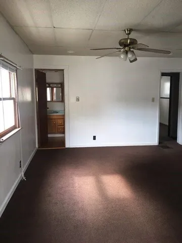 an empty room with windows and entrance