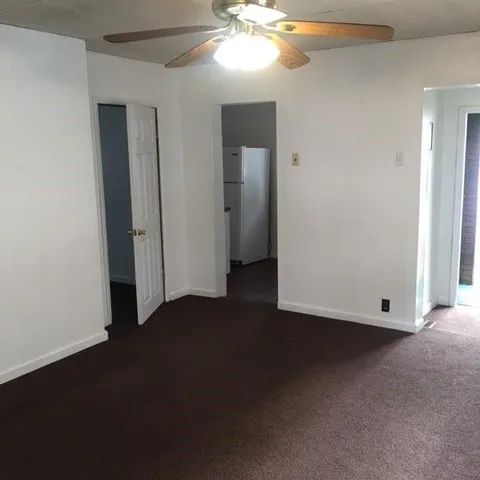 a bathroom with a toilet and a shower curtain