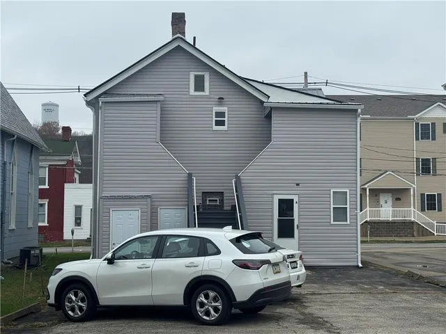 a view of a car parked in front of a house