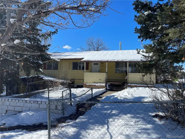 a view of a house with backyard porch and sitting area