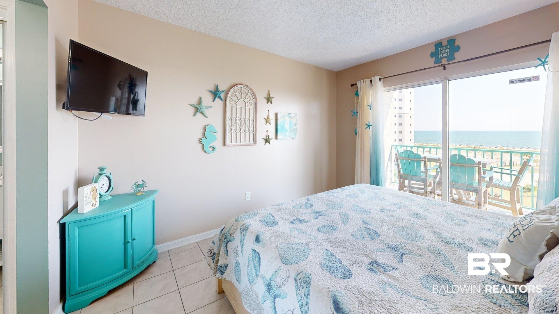 645 Plantation Road, Unit 6503 Gulf Shores, AL 36542 - Photo 7 of 53 Bedroom featuring light tile patterned flooring, a textured ceiling, access to outside, and a water view