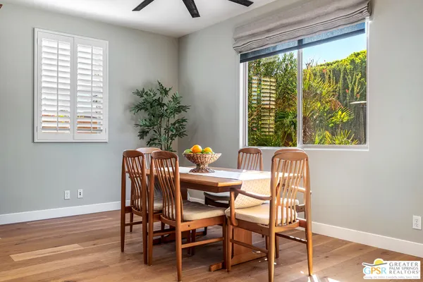 a dining room with furniture a rug and wooden floor
