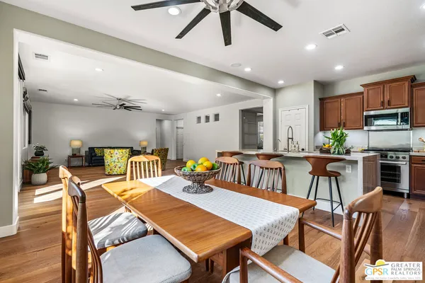 a kitchen with stainless steel appliances kitchen island granite countertop a kitchen island hardwood floor sink and stove
