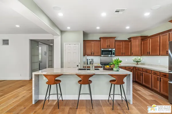 a kitchen with a table chairs and refrigerator