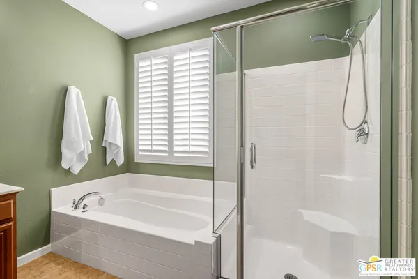 a spacious bedroom with a bed and wooden floor