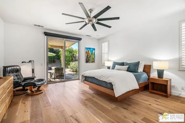 a large bed sitting in a bedroom next to a window