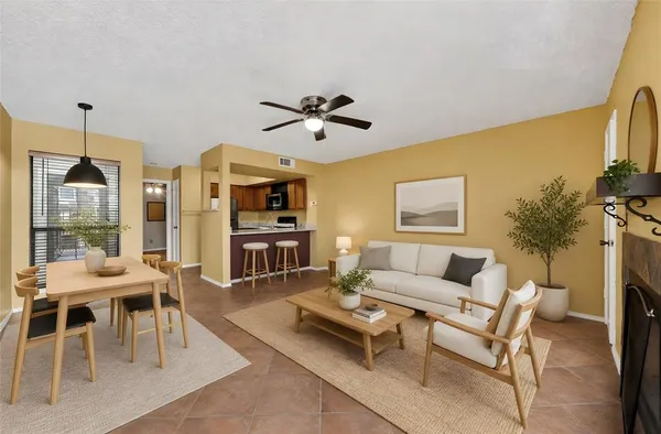 a living room with furniture a table and a large window