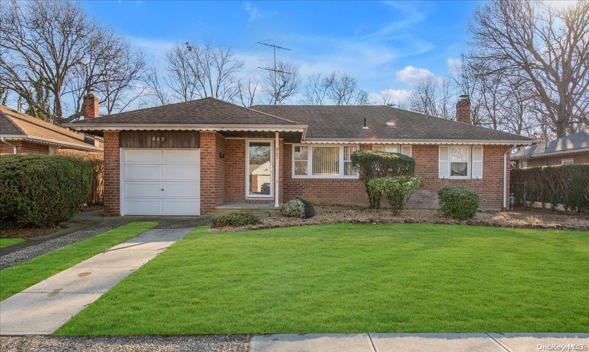 862 Fenimore Place Baldwin, NY 11510 - Photo 1 of 1 a front view of a house with a garden