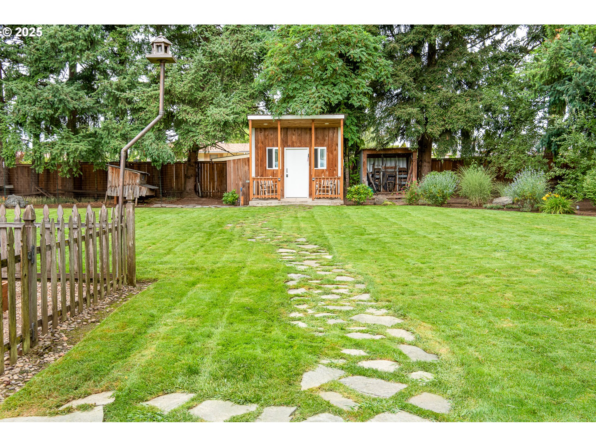 6002 Main Street Springfield, OR 97478 - Photo 36 of 48 a backyard of a house with plants and large trees
