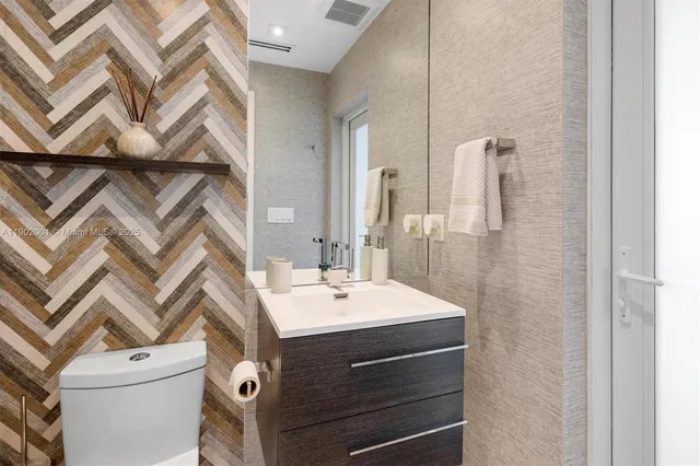 a view of walk in closet with clothes