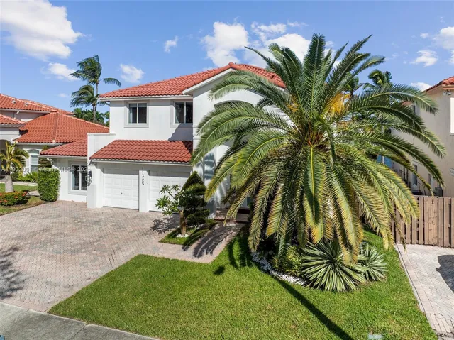 a front view of house with yard and green space