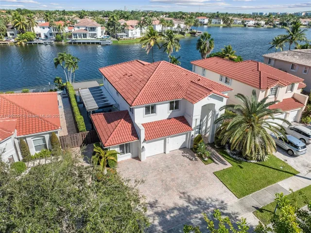 an aerial view of a house with outdoor space and lake view