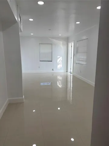 a kitchen with stainless steel appliances granite countertop a refrigerator a stove and a sink