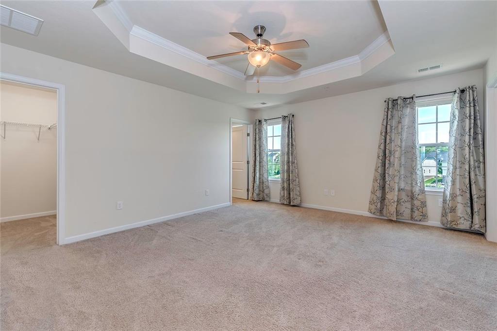 614 Rosecliff Road Wexford, PA 15090 - Photo 12 of 23 This is the spacious master bedroom showing the tray ceiling with the ceiling fan, one of the walk-in closets and entry to the master bath. THE DRAPES AND NOT INCLUDED IN THE SALE but the custom blinds on the windows are included.