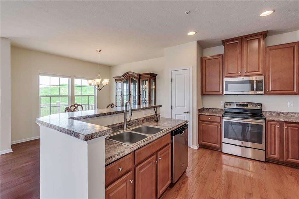 614 Rosecliff Road Wexford, PA 15090 - Photo 9 of 23 This is the kitchen area showing the sink, breakfast bar, pantry and some of the stainless steel appliances.