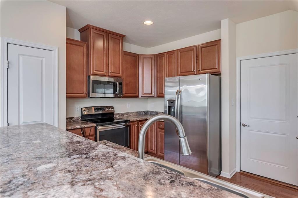 614 Rosecliff Road Wexford, PA 15090 - Photo 10 of 23 This shows the kitchen with the beautiful cabinets, stainless steel appliances and the door to the attached garage (so convenient when you have groceries to carry in)!