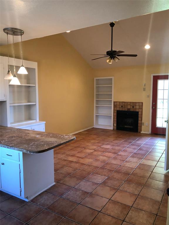 2882 Mackey Lane Shreveport, LA 71118 - Photo 2 of 13 a room with a fireplace and a ceiling fan