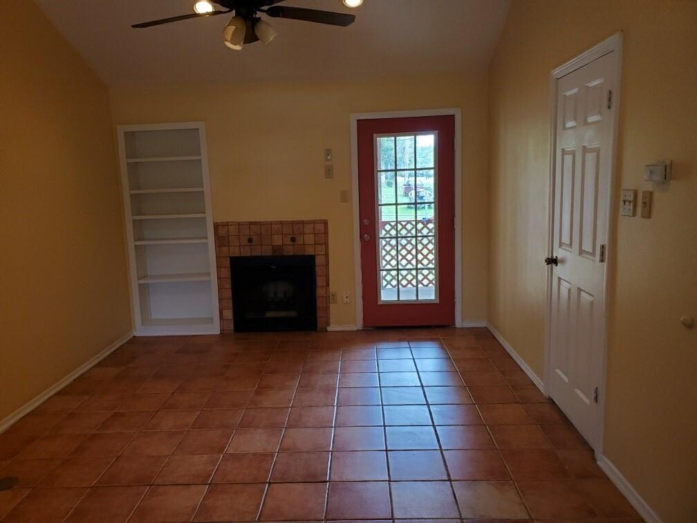 2882 Mackey Lane Shreveport, LA 71118 - Photo 6 of 13 a view of an empty room with a fireplace and a window