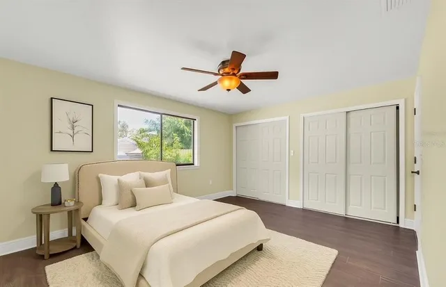 a bedroom with a large bed and a chandelier