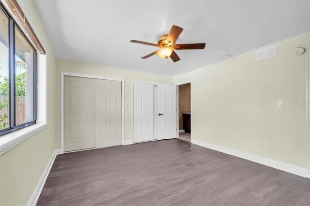 a view of a livingroom with a window and a ceiling fan
