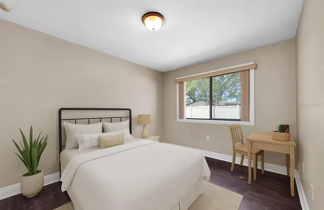 a bedroom with a bed and a window