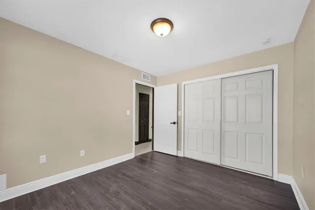a view of a room with wooden floor