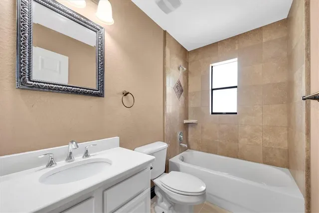 a bathroom with a toilet a sink and bathtub