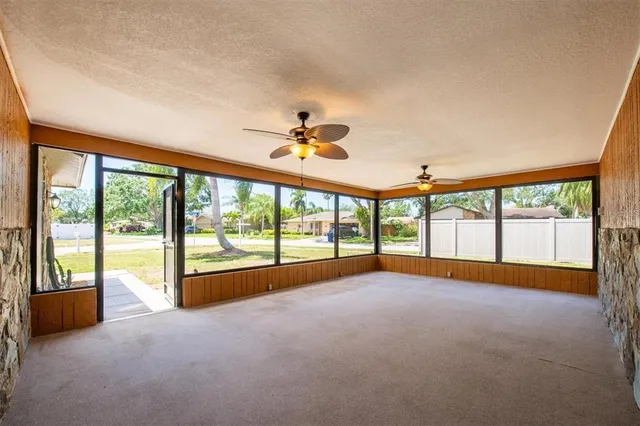 a view of an empty room with a window and a swimming pool