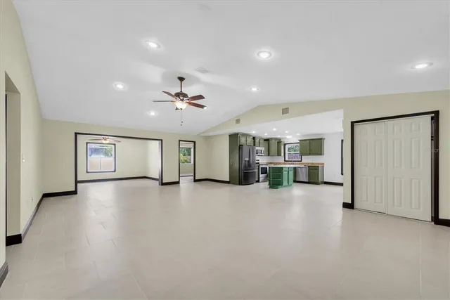 an empty room with projector and furniture