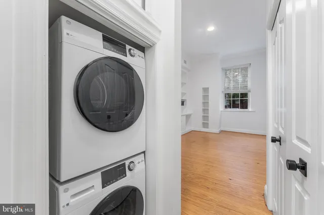 a view of walk in closet with washer and dryer