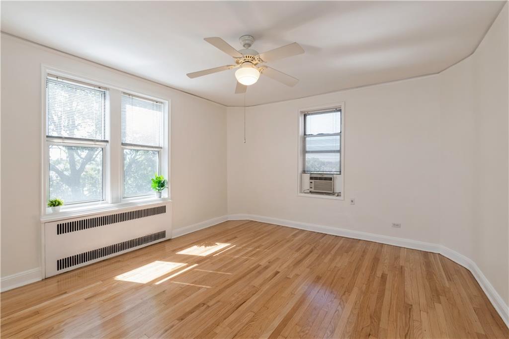601 79th Street, Unit E10 Brooklyn, NY 11209 - Photo 4 of 14 an empty room with wooden floor and windows