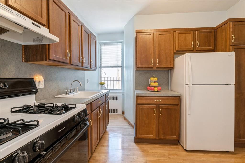601 79th Street, Unit E10 Brooklyn, NY 11209 - Photo 5 of 14 a kitchen with stainless steel appliances granite countertop a refrigerator stove and sink