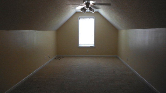 640 Lokchapee Ridge Macon, GA 31210 - Photo 22 of 22 an empty room with a chandelier fan and windows