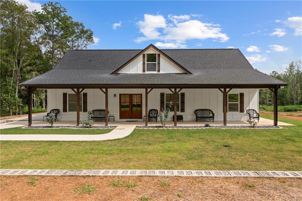 a view of a house with swimming pool and sitting area
