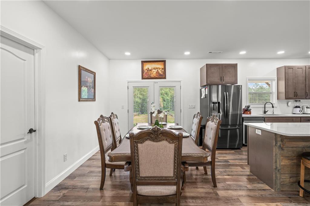 1175 Burwell Mt Zion Road Carrollton, GA 30117 - Photo 13 of 29 a view of a dining room with furniture window and wooden floor