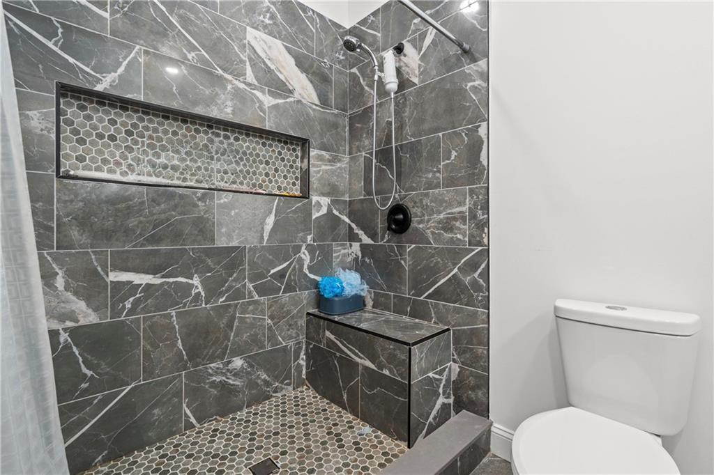 1175 Burwell Mt Zion Road Carrollton, GA 30117 - Photo 14 of 29 a bathroom with a toilet and a shower