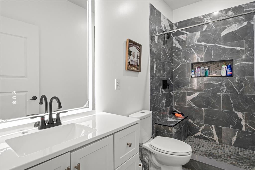1175 Burwell Mt Zion Road Carrollton, GA 30117 - Photo 18 of 29 a bathroom with a sink toilet and shower