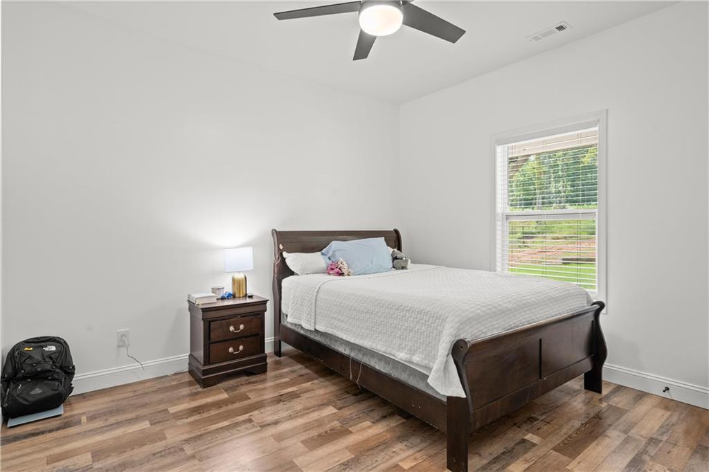 1175 Burwell Mt Zion Road Carrollton, GA 30117 - Photo 19 of 29 a bedroom with a bed and a ceiling fan