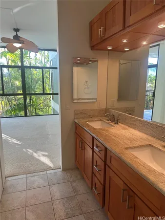 a bathroom with a granite countertop sink and a mirror